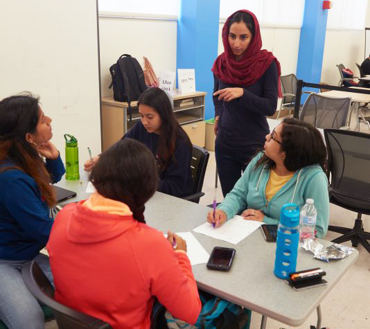 Instructor talking to a group of students